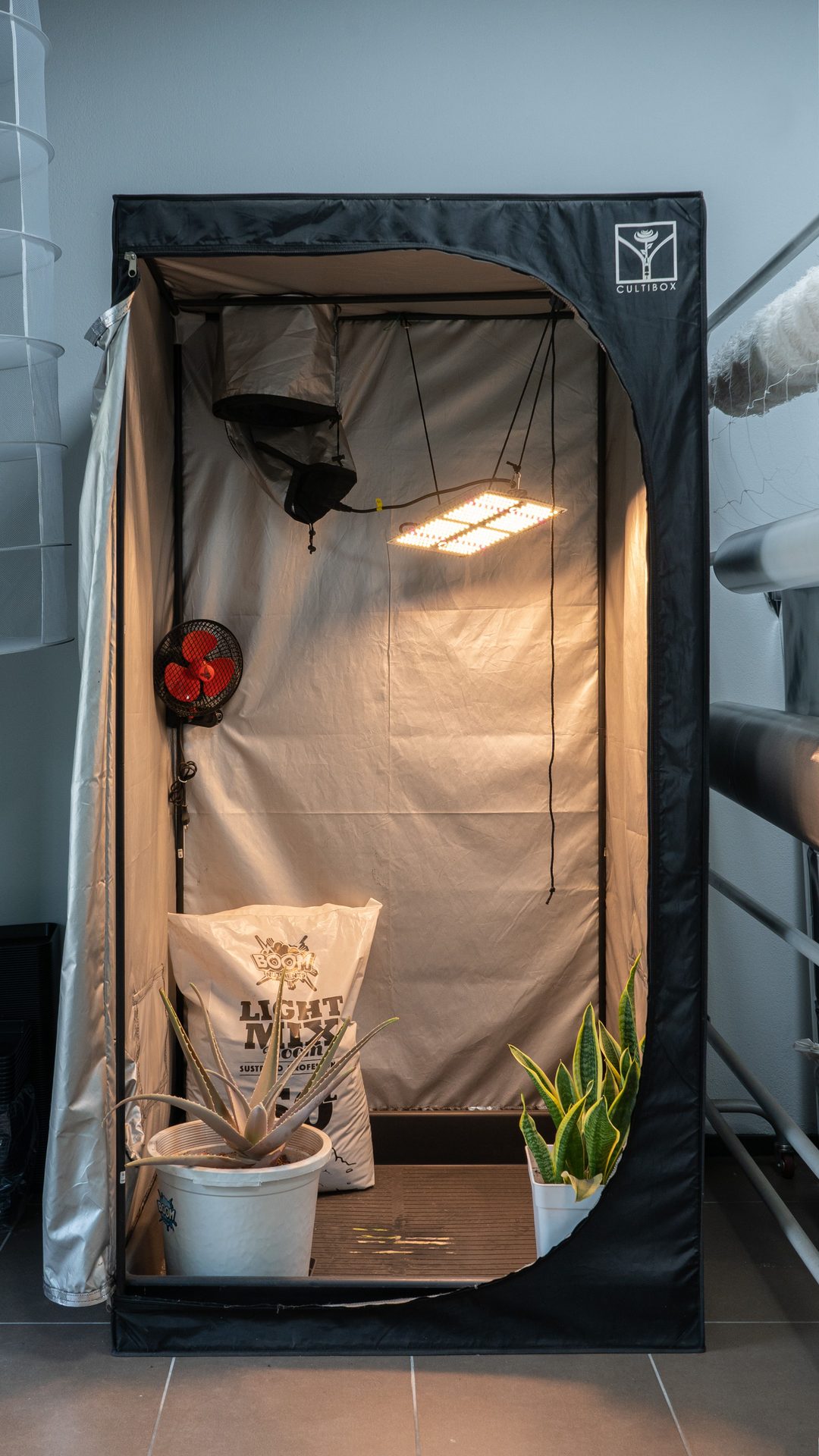 Indoor grow tent lit by a full spectrum LED